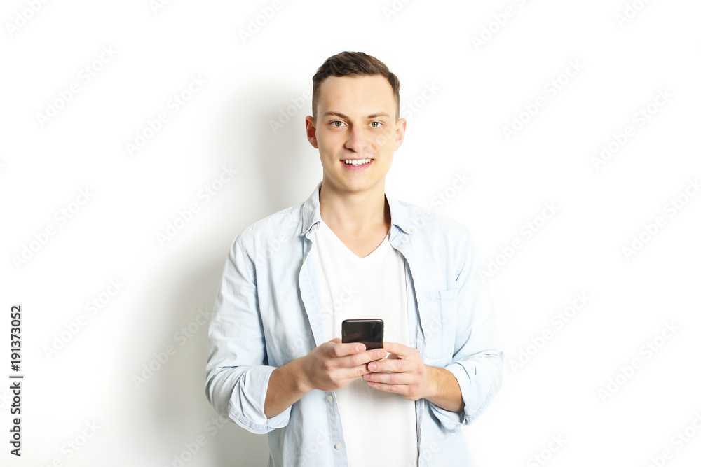 Young man checking mobile phone, reading a message. Technology & relationship concept. Modern romance troubles. Male & female online dating app. Touch screen, chatting, swiping, browsing, surfing. Young man checking mobile phone, reading a message. Technology & relationship concept. Modern romance troubles. Male & female online dating app. Touch screen, chatting, swiping, browsing, surfing.