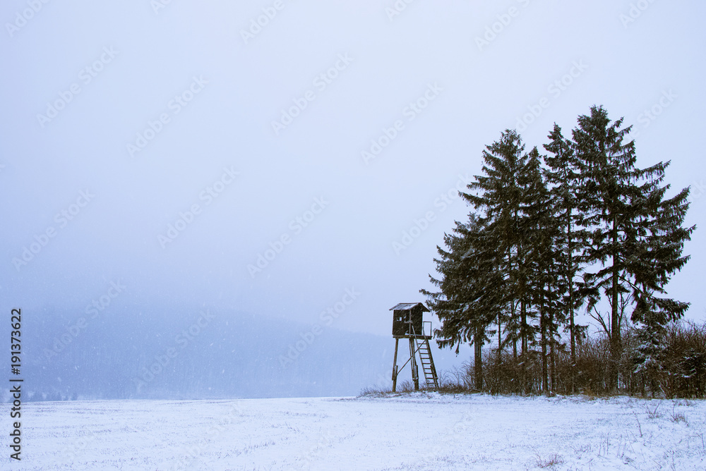 Hunting tower in countryside during heavy snowing Hunting tower in countryside during heavy snowing