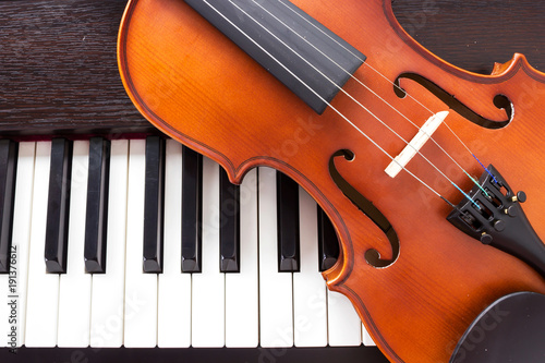 Violin on piano keyboard. Music background. Top view.
