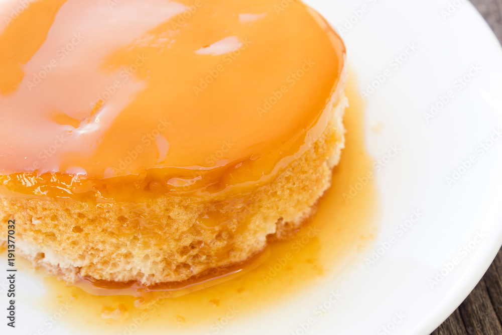 Closeup homemade caramel custard cake on white plate. French dessert. Closeup homemade caramel custard cake on white plate. French dessert.
