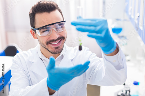Happy cheerful male laboratorian making breakthrough