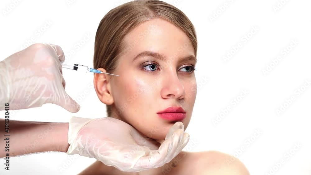 After the professional injection botox into the cheekbones, the girl smiles After the professional injection botox into the cheekbones, the girl smiles