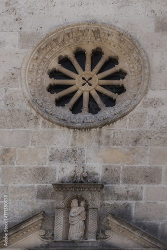 facade of the building with carved window and figure