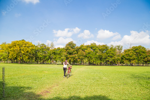 Young asian women with bicycle on green meadow © themorningglory
