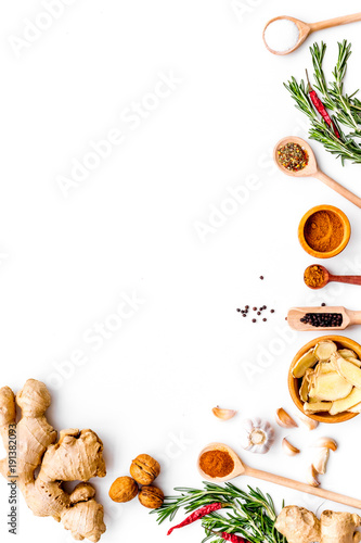 Fototapeta Naklejka Na Ścianę i Meble -  Seasoning background. Dry spices near ginger, garlic, rosemary on white background top view copy space