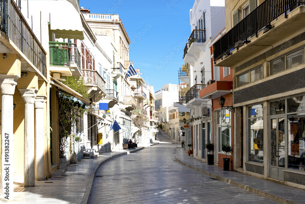 Narrow stone street and buildings in Siros island. Greece.