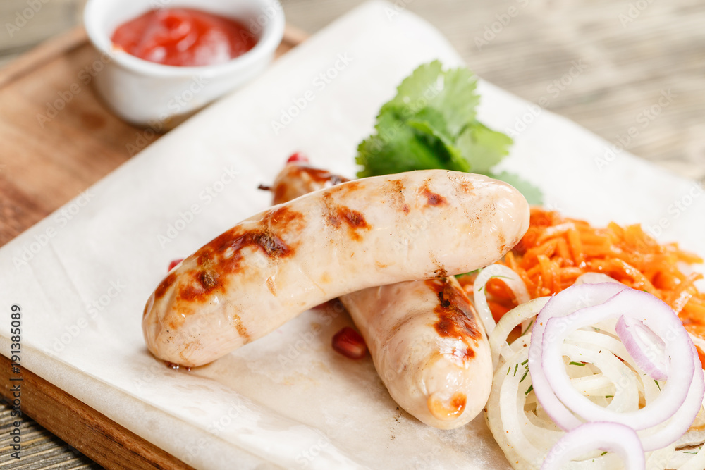 grilled sausages. Serving on a wooden Board on a rustic table. Barbecue restaurant menu, a series of photos of different meats grilled sausages. Serving on a wooden Board on a rustic table. Barbecue restaurant menu, a series of photos of different meats