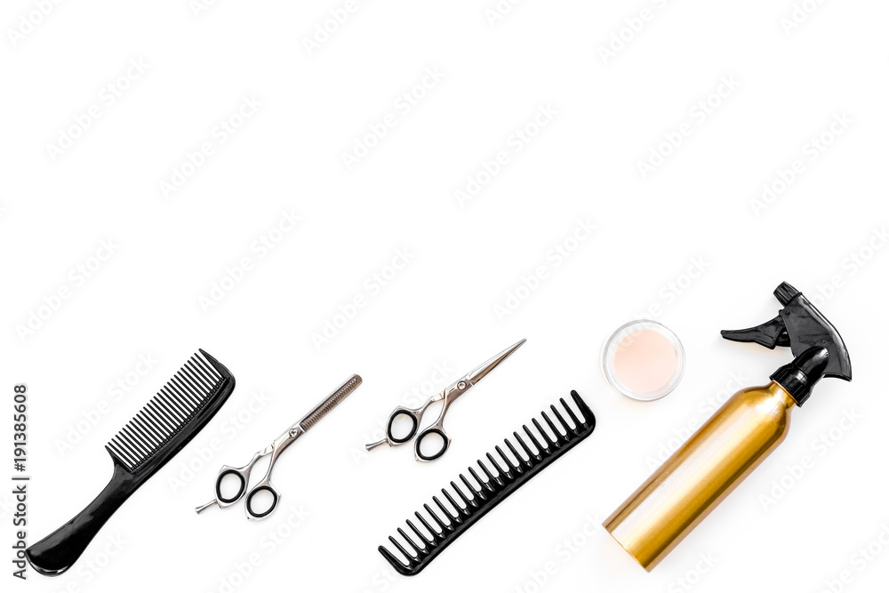 Professional tools for haircut. Sciccors, comb, spray on white background top view copy space