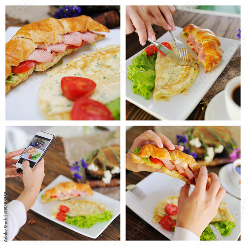an appetizing breakfast - a croissant with ham and tomatoes and an omelette with salad on a wooden background. Female hands are taking food on a smartphone