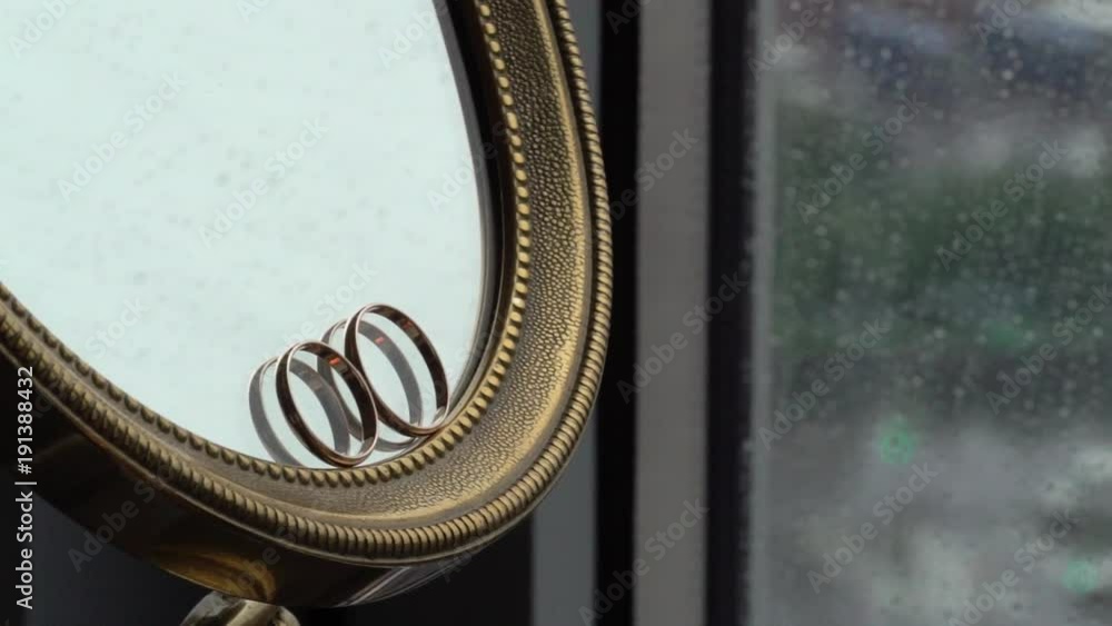 Wedding rings at the mirror indoors Wedding rings at the mirror indoors