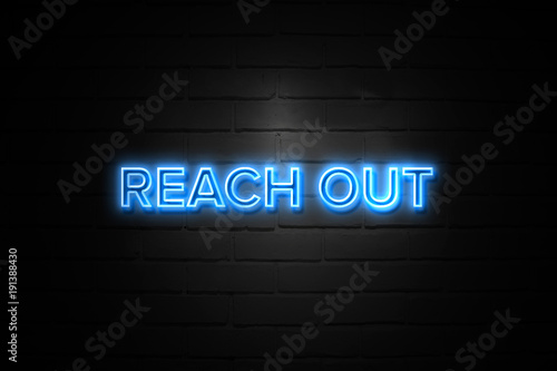 Reach Out neon Sign on brickwall