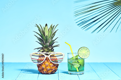 Tropical Pineapple Hipster with Cocktail on Beach. Bright Summer Color. Trendy fashion Style. Hot summer Vibes. Creative Art. Fun party Mood. Minimal