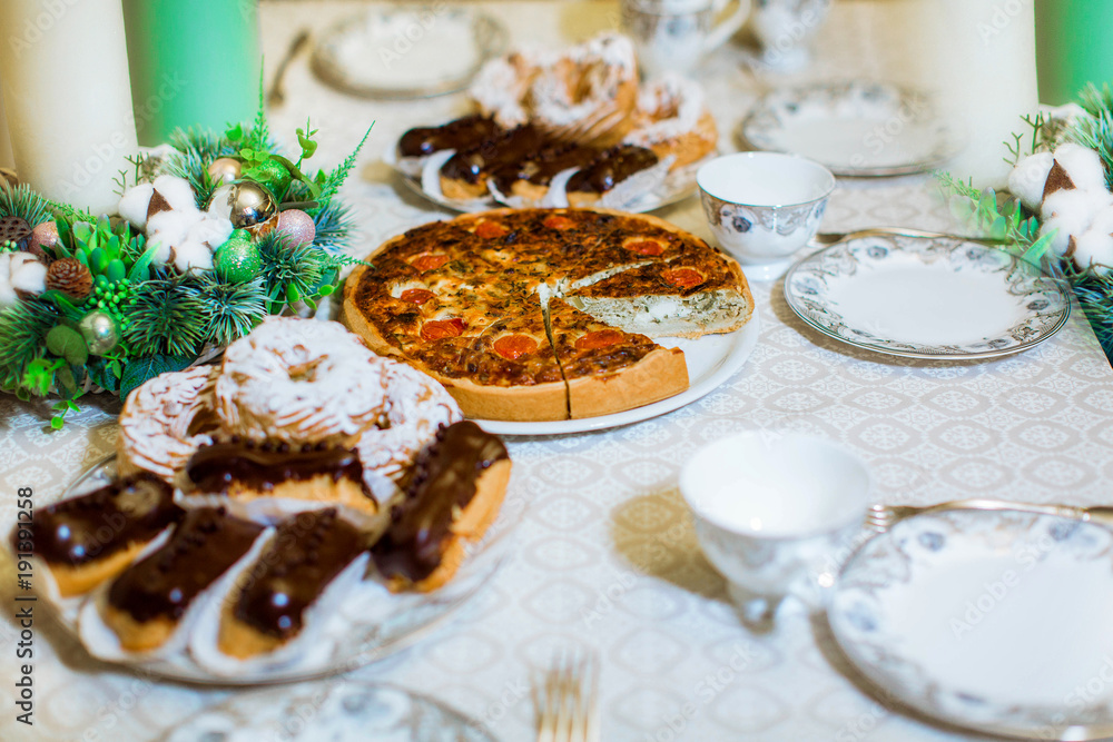 Fruit sweet pie and eclairs on the table Fruit sweet pie and eclairs on the table