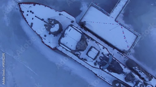 The boat is covered with snow in the ice