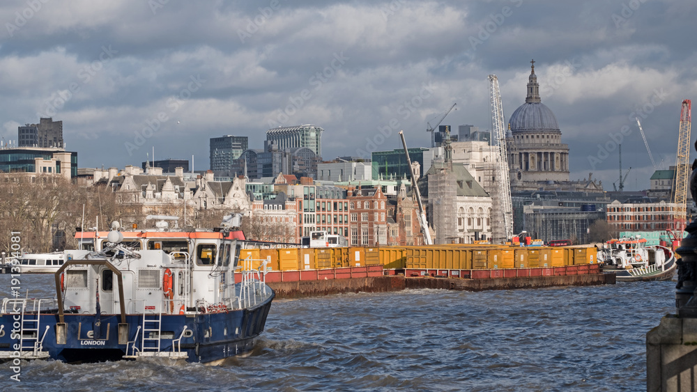 Fototapeta premium Traffic on the river Thames, London, near Waterloo Bridge with St Paul’s cathedral in the background