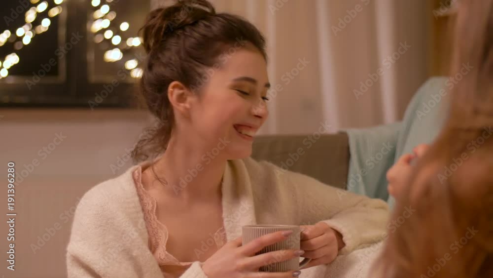 woman drinking tea and talking to friend at home woman drinking tea and talking to friend at home