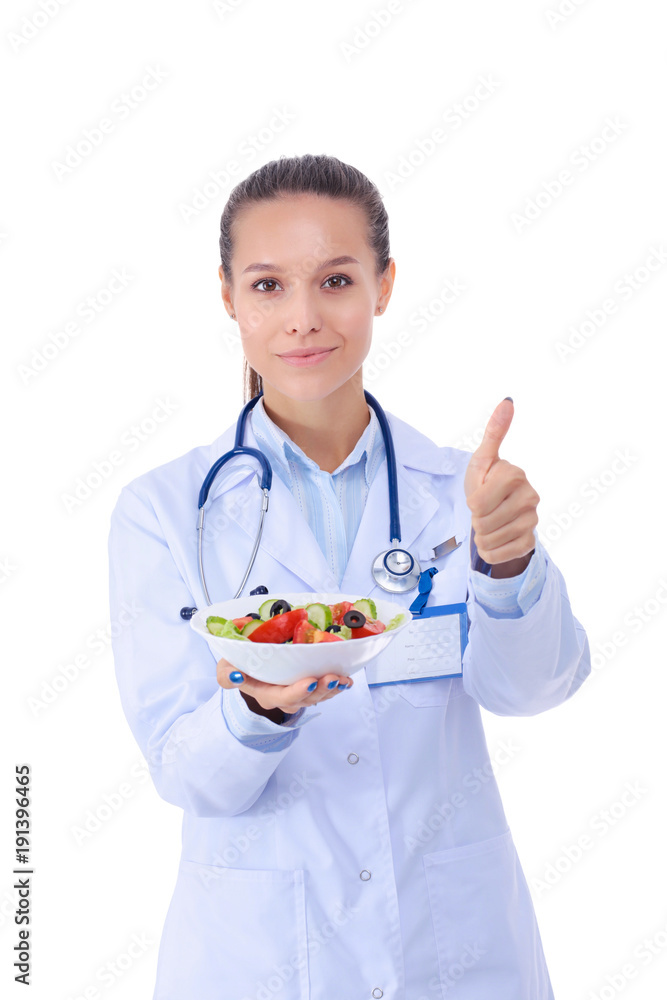 Portrait of a beautiful woman doctor holding a plate with fresh vegetables. Woman doctors. Portrait of a beautiful woman doctor holding a plate with fresh vegetables. Woman doctors.