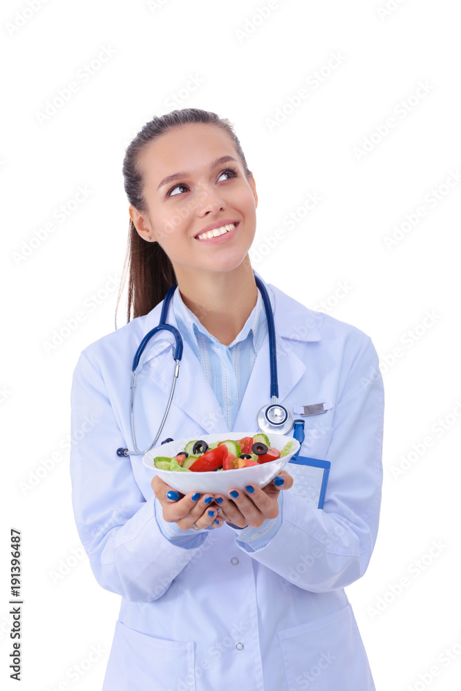 Portrait of a beautiful woman doctor holding a plate with fresh vegetables. Woman doctors. Portrait of a beautiful woman doctor holding a plate with fresh vegetables. Woman doctors.