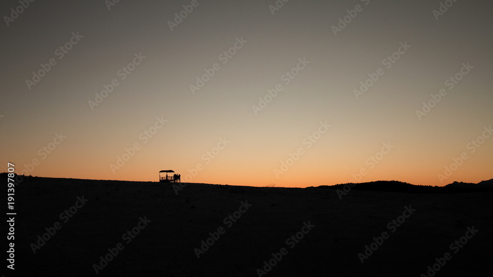 Silhouette of a mountain landscape in the snow with people