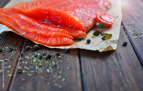 Red fish salmon with some ingredients on a wooden table of a famous cuisine. Healthy food concept.