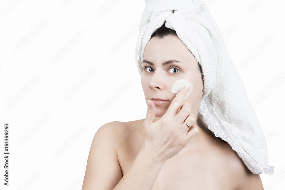 Spa girl applying facial mask isolated on white background. Beauty treatments. Beauty and body skin care concept. Cream mask on face of attractive girl Spa girl applying facial mask isolated on white background. Beauty treatments. Beauty and body skin care concept. Cream mask on face of attractive girl