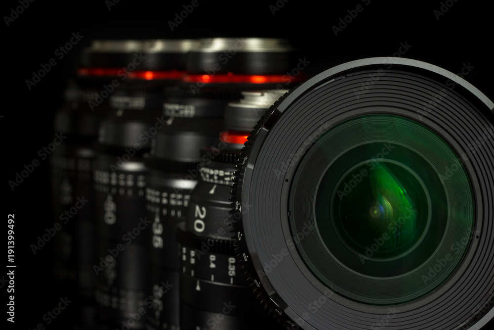 Professional Cinema Lens - concept of camera lenses on the mirroring black background.
