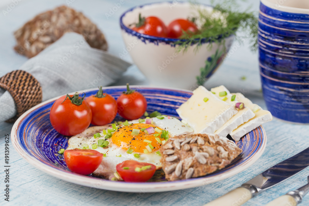 Coffee cup, one egg, cheese and cherry tomatoes for healthy breakfast.