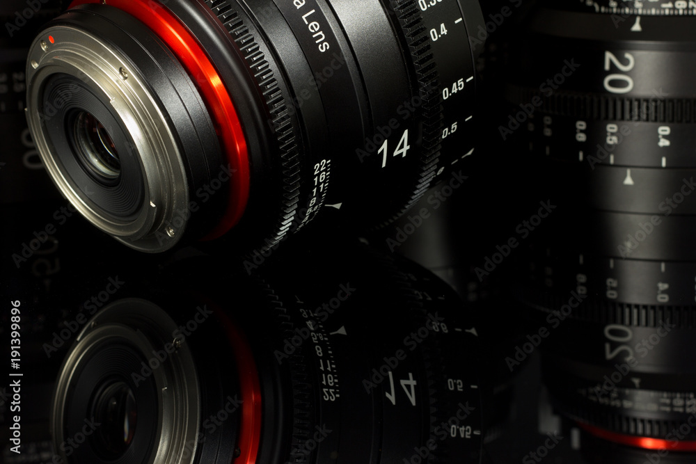 Professional Cinema Lens - concept of camera lenses on the mirroring black background. Professional Cinema Lens - concept of camera lenses on the mirroring black background.