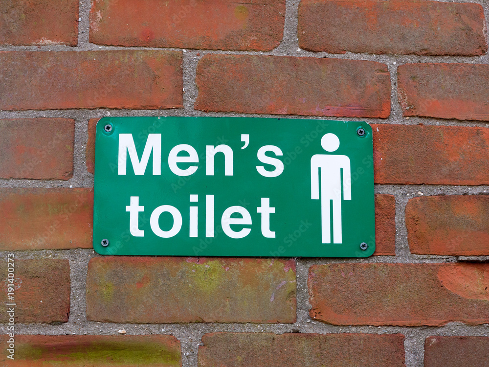 close up green and white men's toilet sign wall