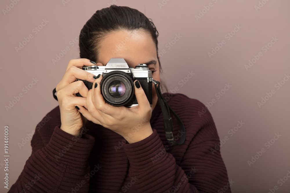 Photographer taking photos with a old SLR camera Photographer taking photos with a old SLR camera