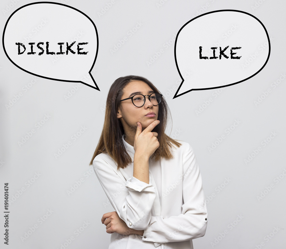 Young pretty asian woman thinking about choice between like and dislike. Businesswoman choosing concept. Selective focus and shallow DOF Young pretty asian woman thinking about choice between like and dislike. Businesswoman choosing concept. Selective focus and shallow DOF