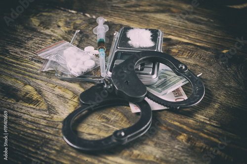 Illegal drugs, money and handcuffs