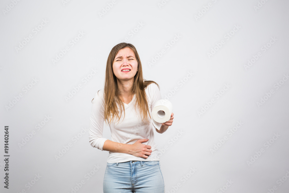 Woman with toilet paper and problems with her digestive system Woman with toilet paper and problems with her digestive system