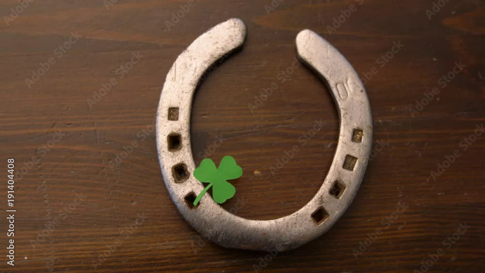 horseshoe with shamrock on wooden background horseshoe with shamrock on wooden background