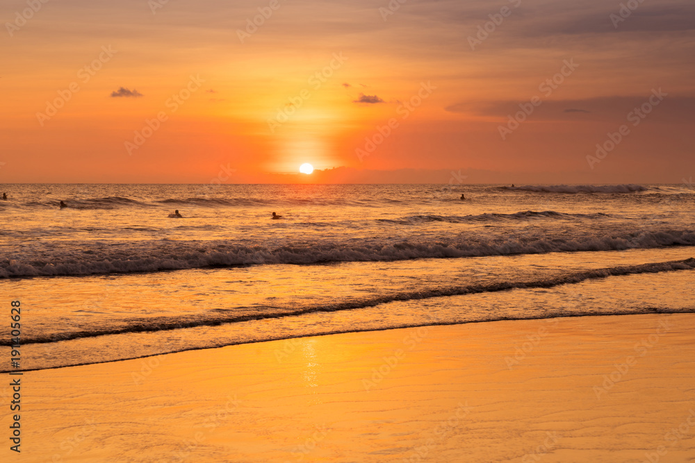 Beach with people in sunset