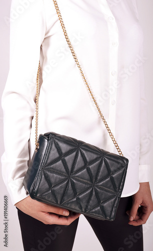 Obraz na płótnie Black Women's handbag in hand, Ladies bag, Black female clutch,Black clutch.Women's bag isolated white background.Bag isolated white background.Clutch isolated white background. w salonie