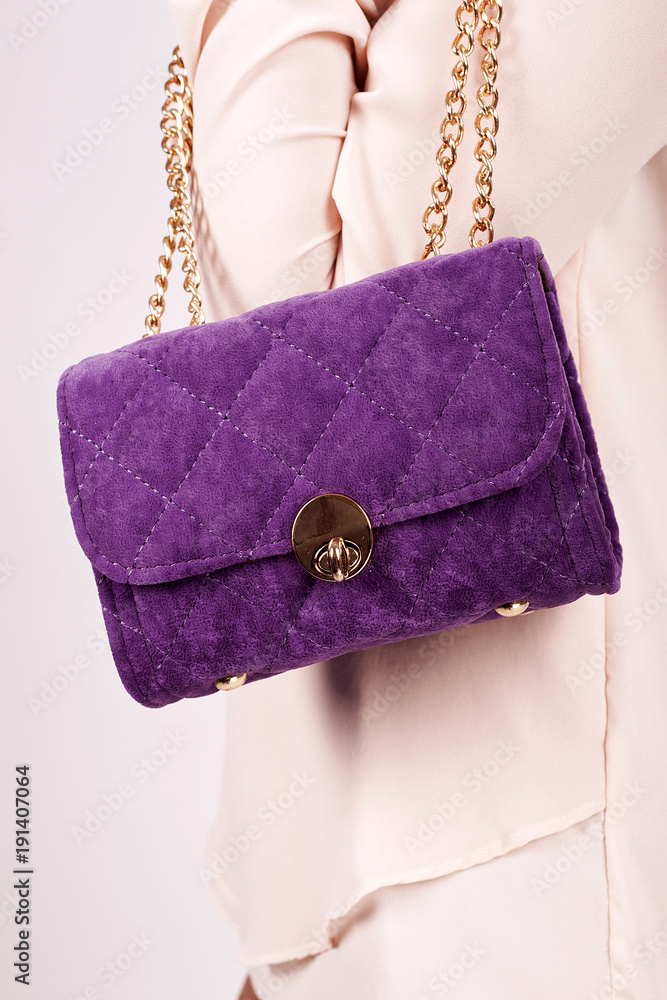 Purple Women's handbag in hand, Ladies bag, Purple female clutch, Purple clutch.Women's bag isolated white background.Bag isolated white background.Clutch isolated white background.