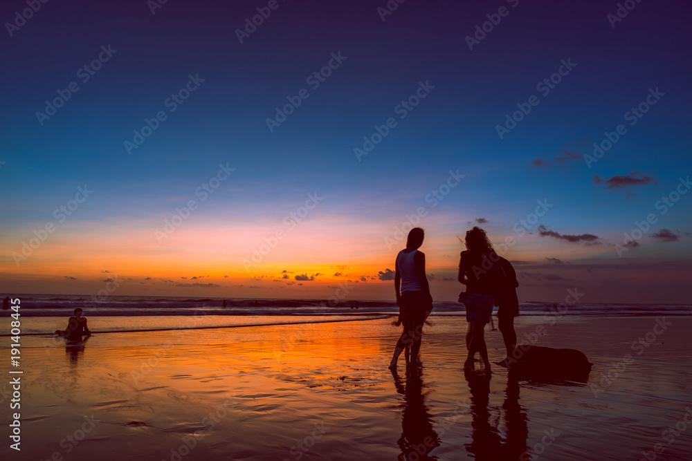 Beach with people in sunset