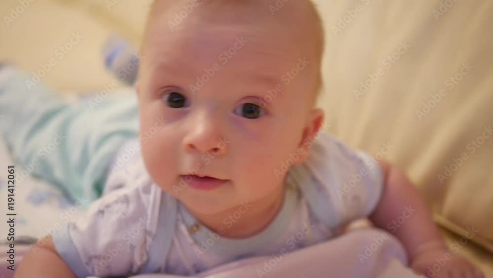 Portrait of a crawling baby on the bed in her room Portrait of a crawling baby on the bed in her room