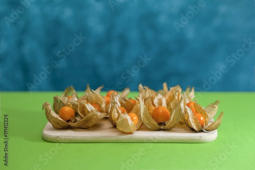 Ground cherry husk tomato chinese lantern on a wooden board photo