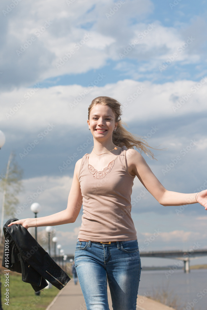 Fototapeta premium Girl with blond hair on the promenade