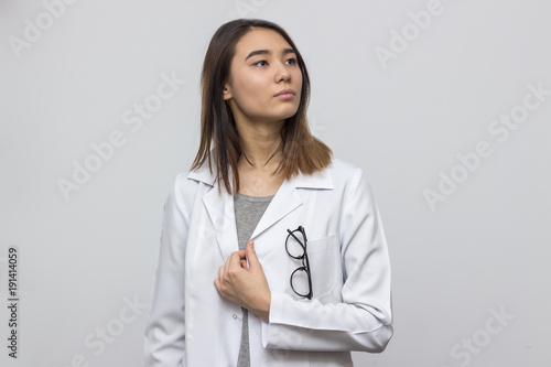 Portrait of young attractive asian doctor with glasses in pocket. Medicine and healthcare concept. Selective focus and shallow DOF