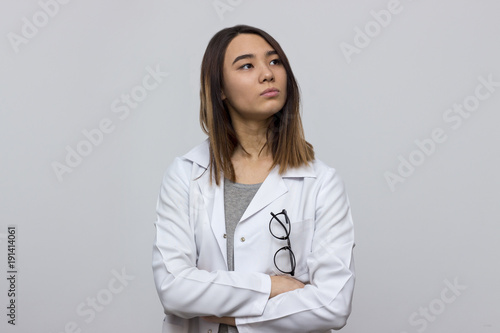 Portrait of young attractive asian doctor with glasses in pocket. Medicine and healthcare concept. Selective focus and shallow DOF