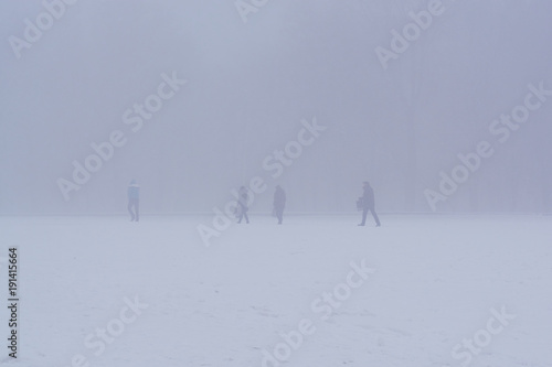 People walking in extreme city cold, snow and fog