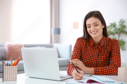 Young woman working in home...