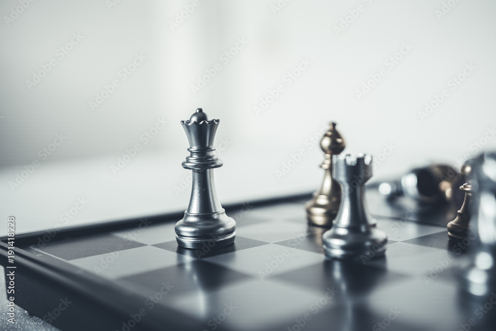 Investment Leadership Concept : The king chess piece with chess others  nearby go down from floating board game concept of business ideas and  competition and strategy plan success meaning. Stock Photo