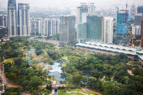 Photography Urban views of Kuala Lumpur with tall skyscrapers, drowning in the greenery of p