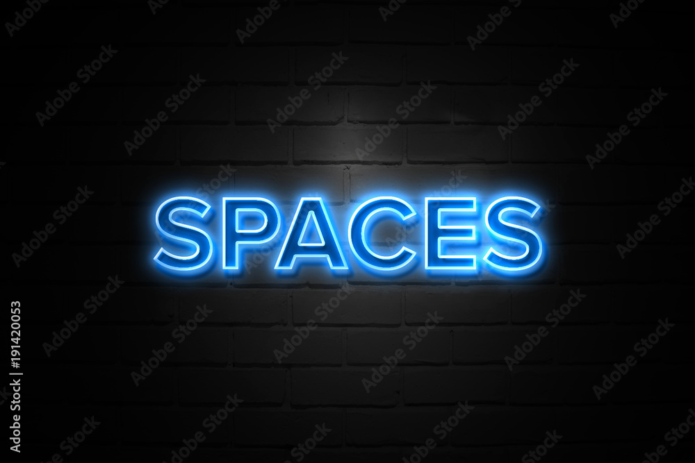 Spaces neon Sign on brickwall