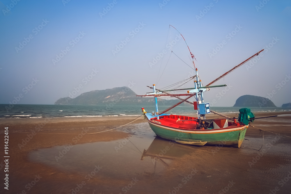 Wooden fishing boat on the coast of Thailand Wooden fishing boat on the coast of Thailand