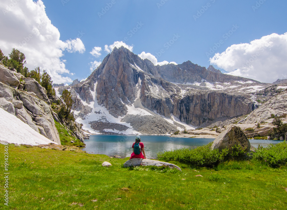 Naklejka premium Girl Next to Beautiful Mountain Lake